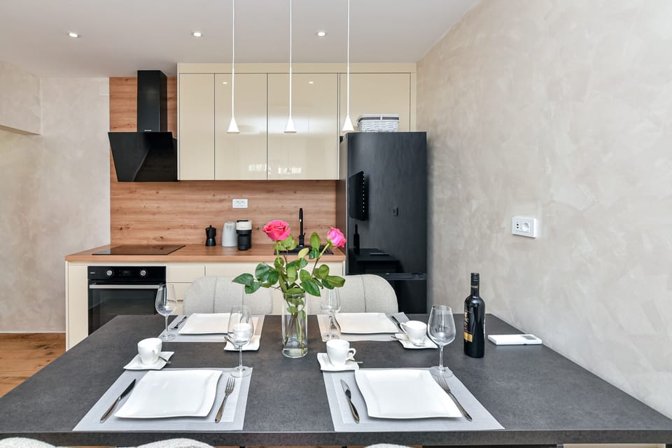 Spacious dining area with a fully equipped kitchen, including dishwasher.