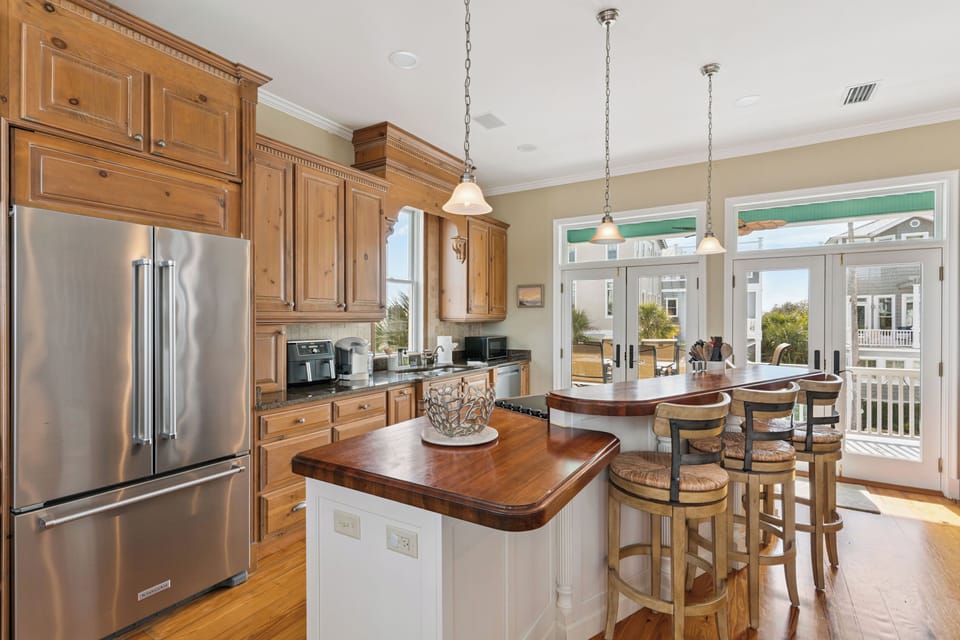 Your gourmet kitchen invites culinary adventures with rich wood cabinetry, granite counters, and a cozy breakfast bar.