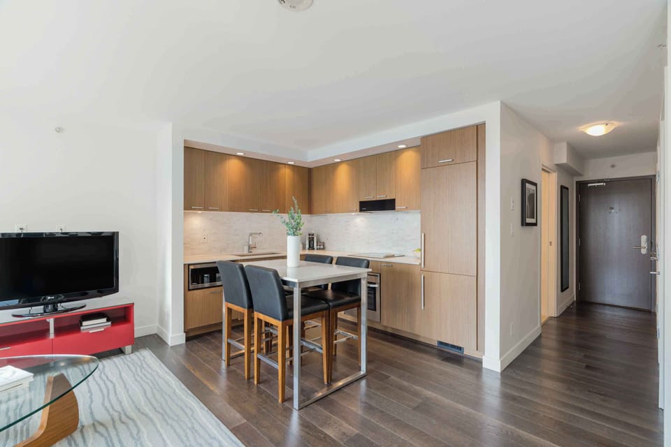 Contemporary studio interior highlighting the dining area, kitchen, and open living space.