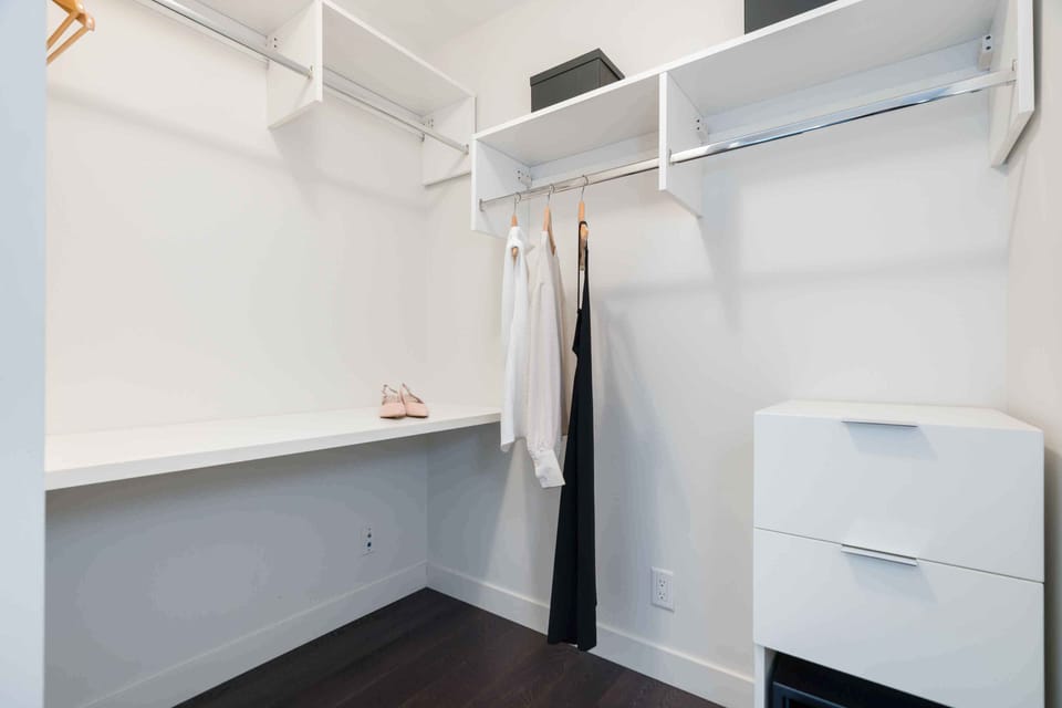 Open walk-in closet providing ample storage space for clothing and luggage.