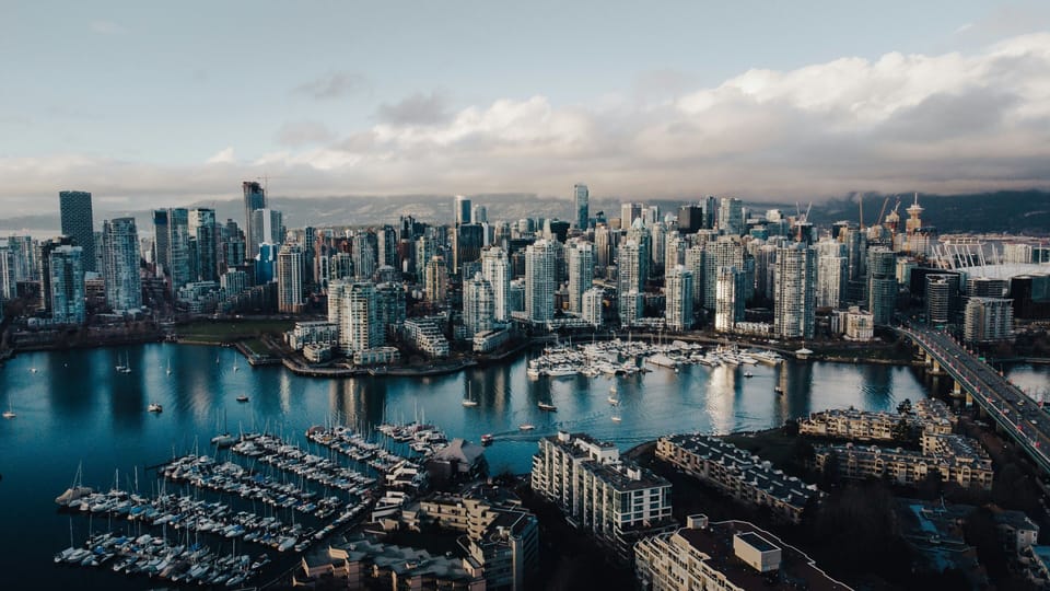 Vancouver's iconic downtown core, surrounded by water, mountains, and vibrancy.