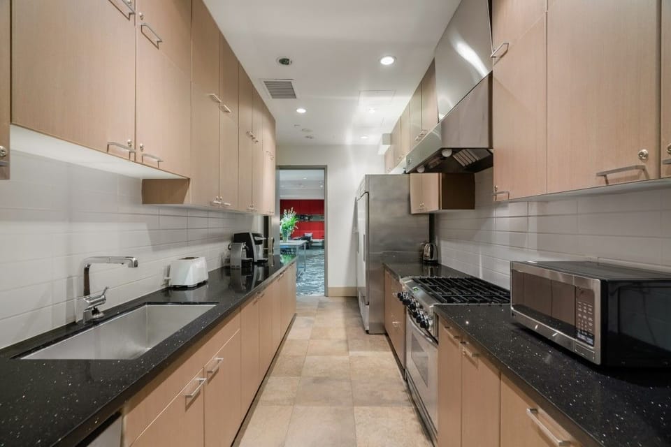 This sleek kitchen features contemporary cabinetry and modern appliances, designed for both functionality and style, perfect for culinary enthusiasts.