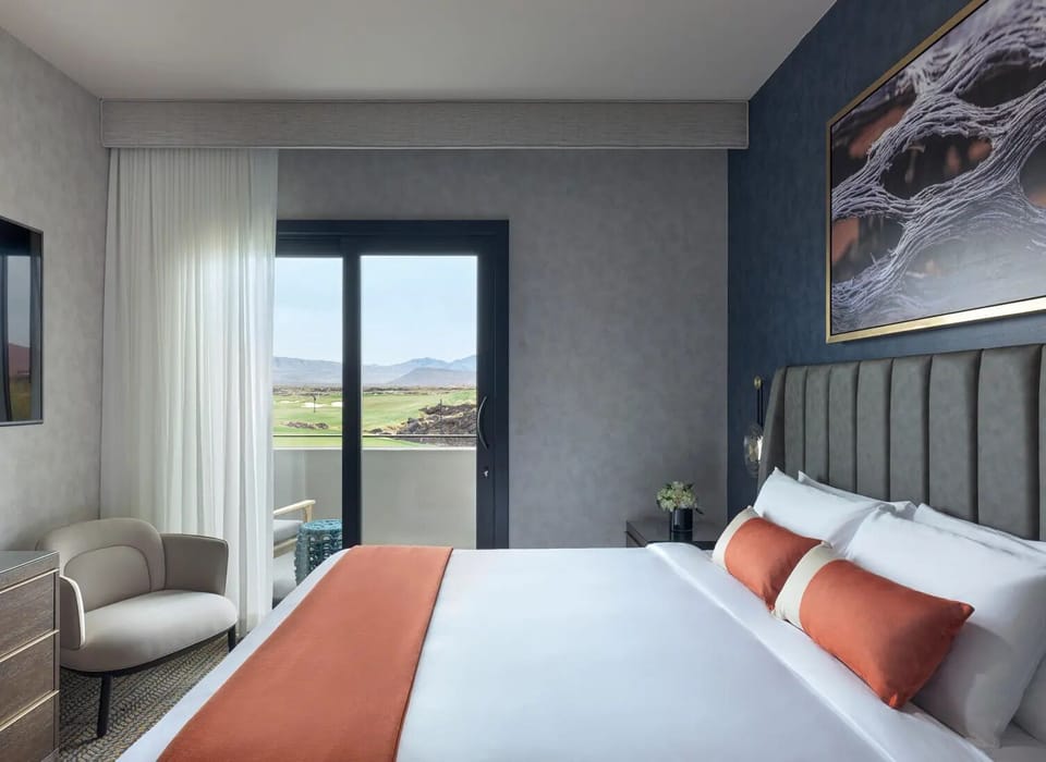 Settle in with crisp linens and a private balcony doorway.