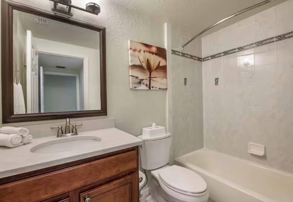 Refresh comfortably with a spotless vanity and bright, tiled bath.