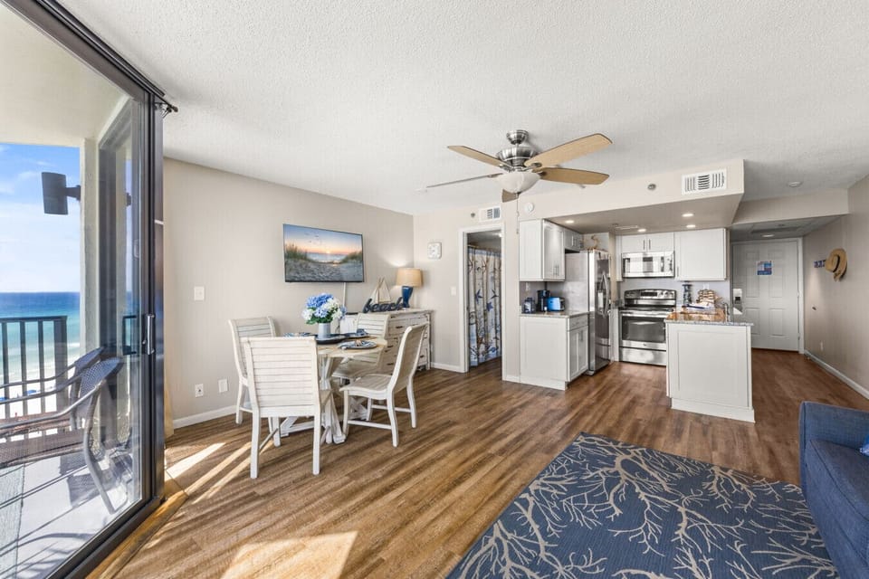 Spacious open layout connecting the kitchen, dining, and living areas with stunning Gulf views
