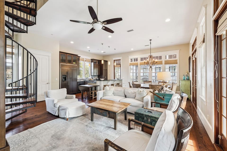 Relax in your spacious open-concept living space with soaring ceilings, elegant spiral staircase, and plush seating perfect for unwinding after exploring.