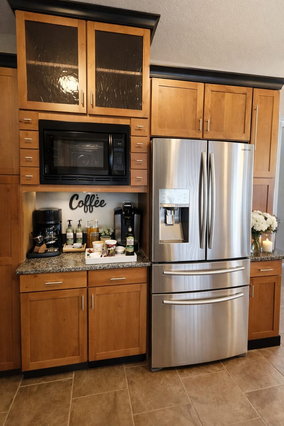 Modern kitchen with stainless steel refrigerator, built-in microwave, and coffee station—perfect for convenient and comfortable vacation living.