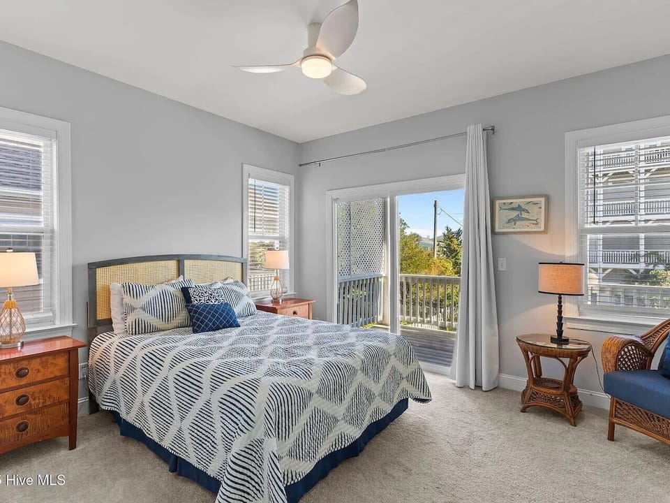 bedroom with a deck and a view