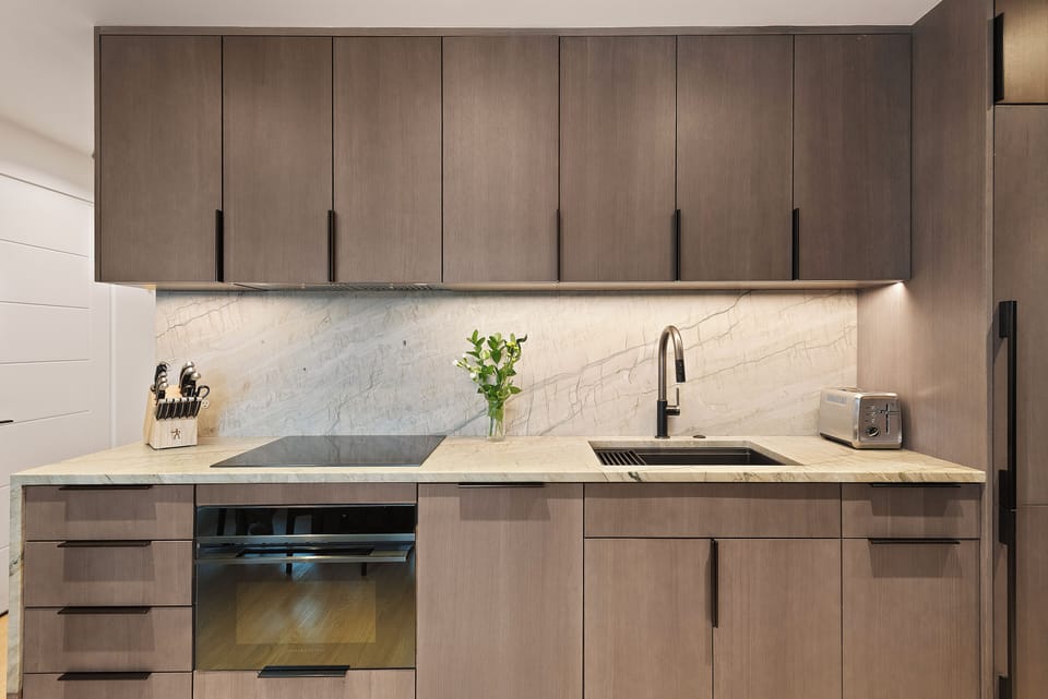 Fully-equipped kitchen with beautiful sleek cabinetry and high-end fixtures.