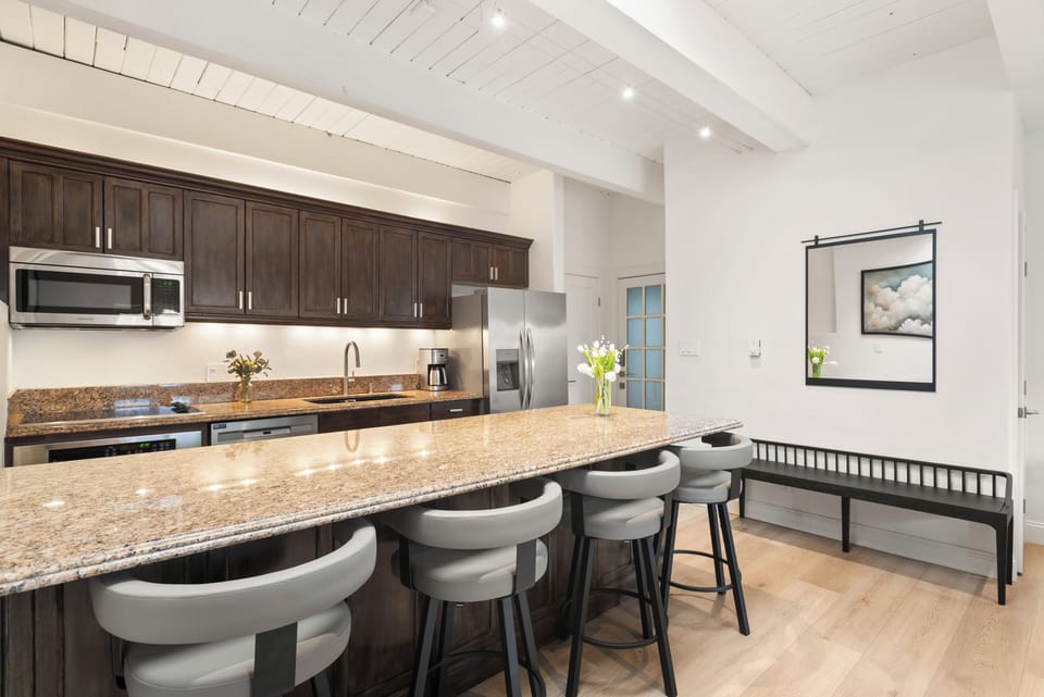 Fully equipped kitchen with seating for 4. The skylights bring in additional natural light and all have electronic blinds if needed.