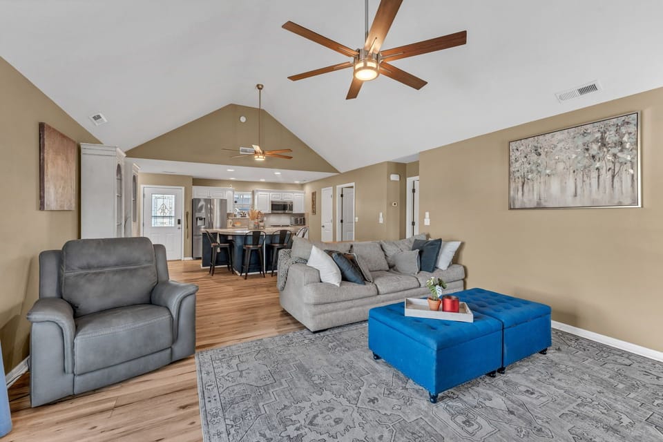 Open concept living room with cozy seating, Smart TV, and easy flow into kitchen