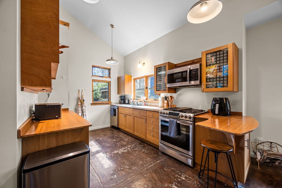 The kitchen is equipped with all the basics needed to prepare meals. A gas range, a drip coffee maker, air fryer, toaster oven, and a kettle complete the kitchen set up.