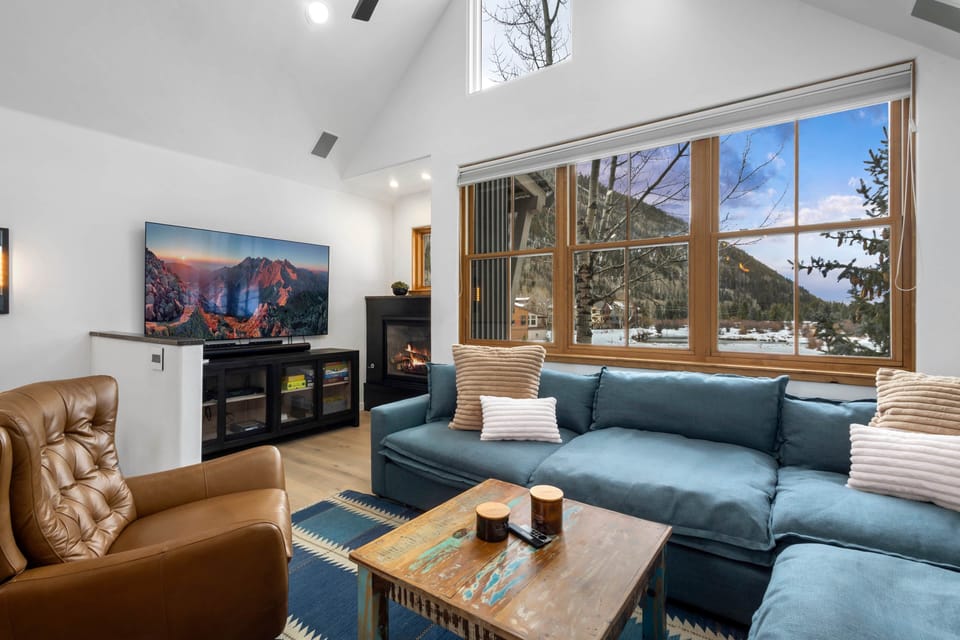 Living room with comfortable seating and a  75" TV