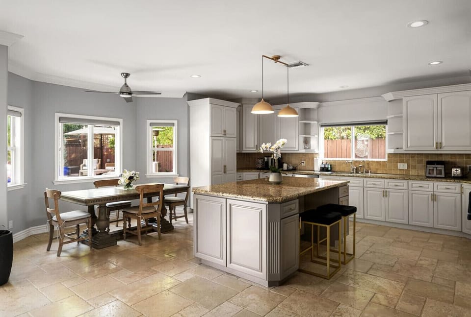 Modern kitchen with seamless access to comfortable lounges and backyard views.