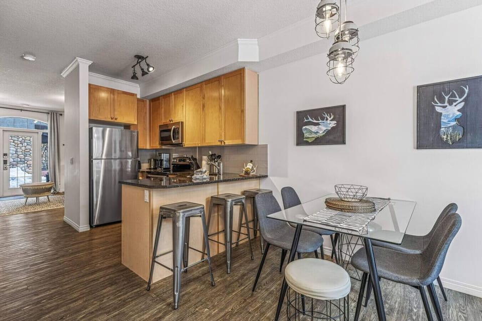 Dining area includes a table + breakfast bar.
