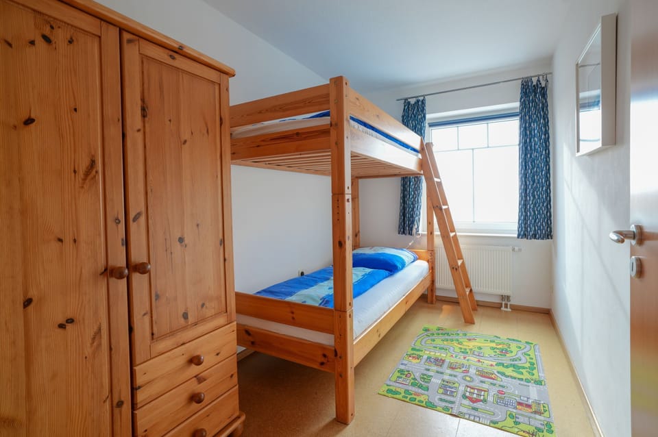 Bedroom with bunk bed and wardrobe.