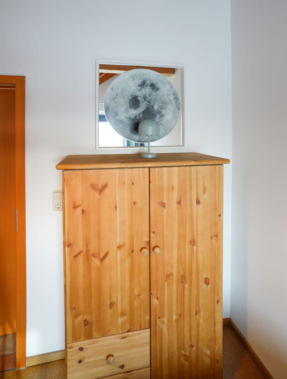 Discover the comfort of this stylish bedroom with a wooden wardrobe and modern flair.