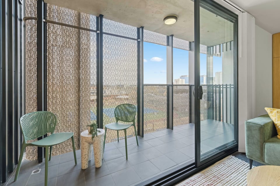 Balcony with two chairs and wind guards and a lovley plinth to rest a drink on! 