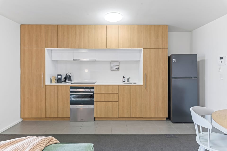 Full kitchen with a small dishwasher for convinence located under the oven and a full sized fridge