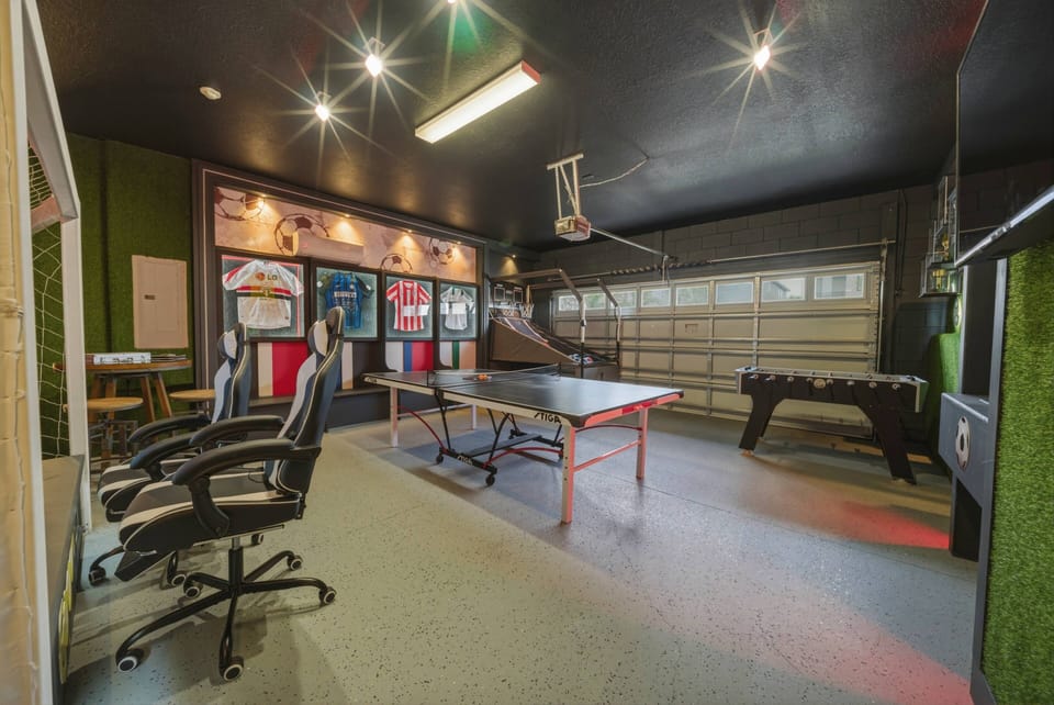 Enjoy our lively game room, complete with a sleek ping pong table and foosball for friendly competition. The vibrant decor and bold black ceiling create an energetic space, perfect for unwinding after a day of adventure.