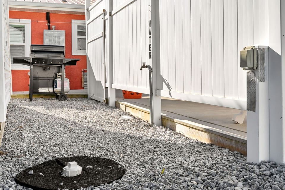 Step into your outdoor oasis where a sleek BBQ awaits your culinary adventures, while the outdoor shower refreshes after sunny days exploring.