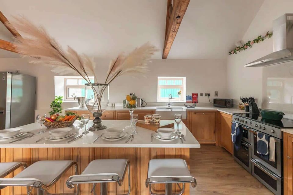 Cook up a storm in this charming barn-inspired kitchen, featuring warm wooden finishes, modern appliances, and plenty of counter space. The perfect blend of rustic character and contemporary convenience makes every meal feel cozy and inviting.