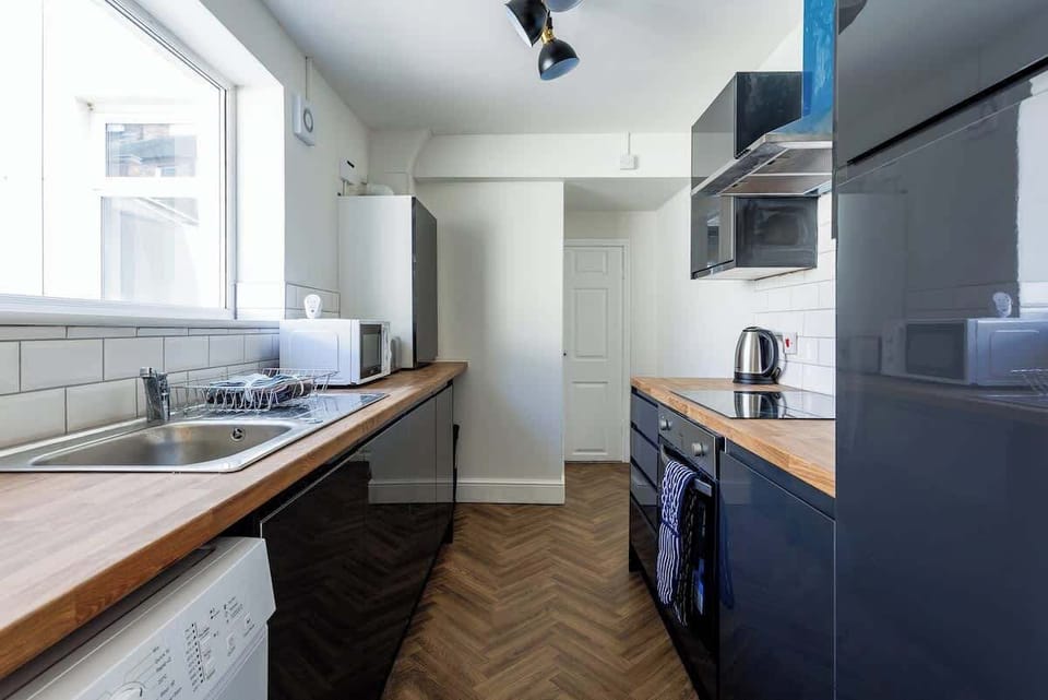A bright, well-equipped kitchen with modern appliances and plenty of workspace for preparing meals.