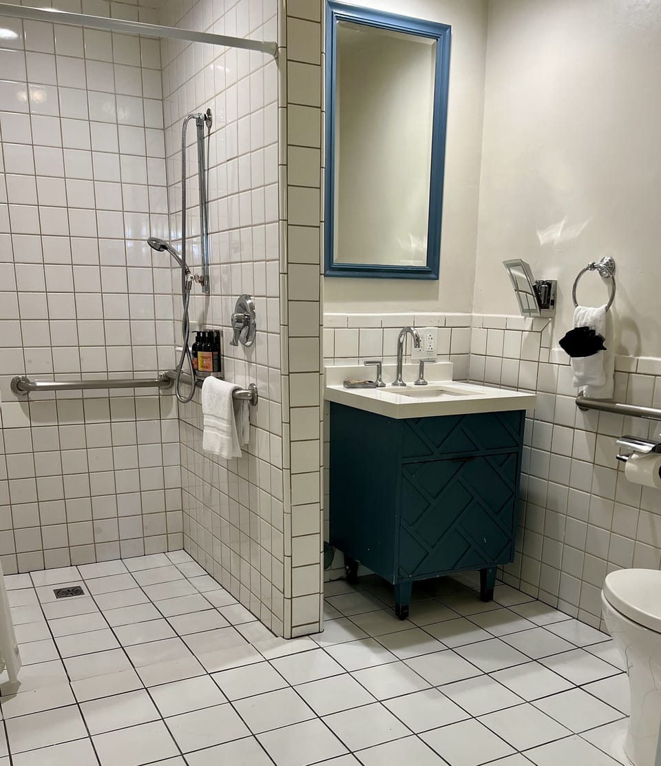 Refresh in a spotless walk-in shower with easy-access grab bars.