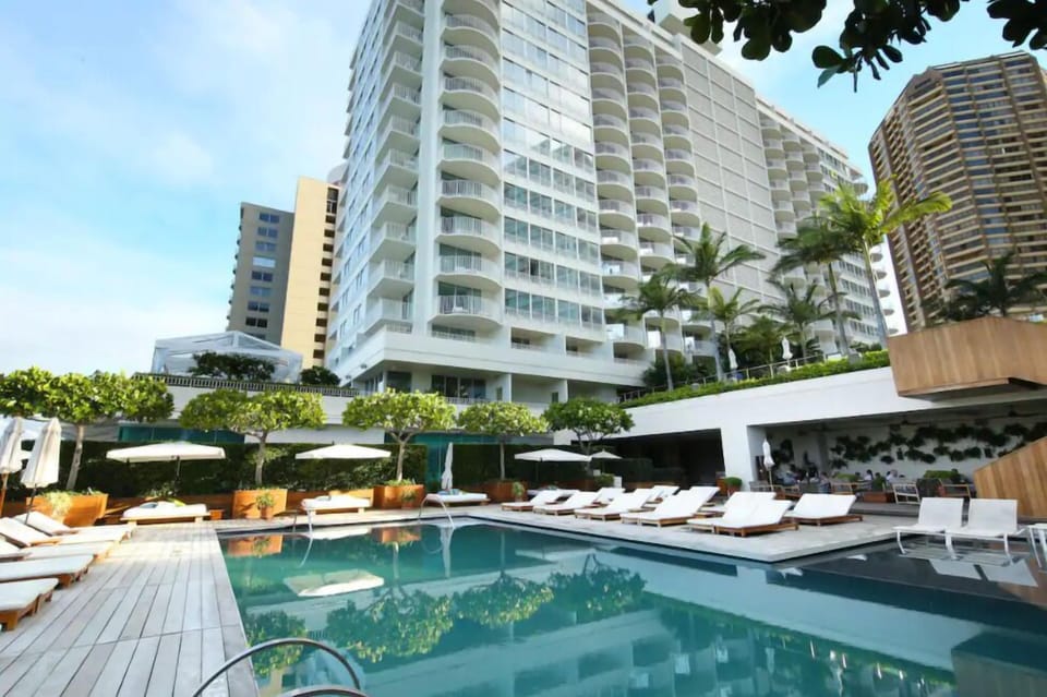 Unwind beside the sparkling pool framed by resort towers.