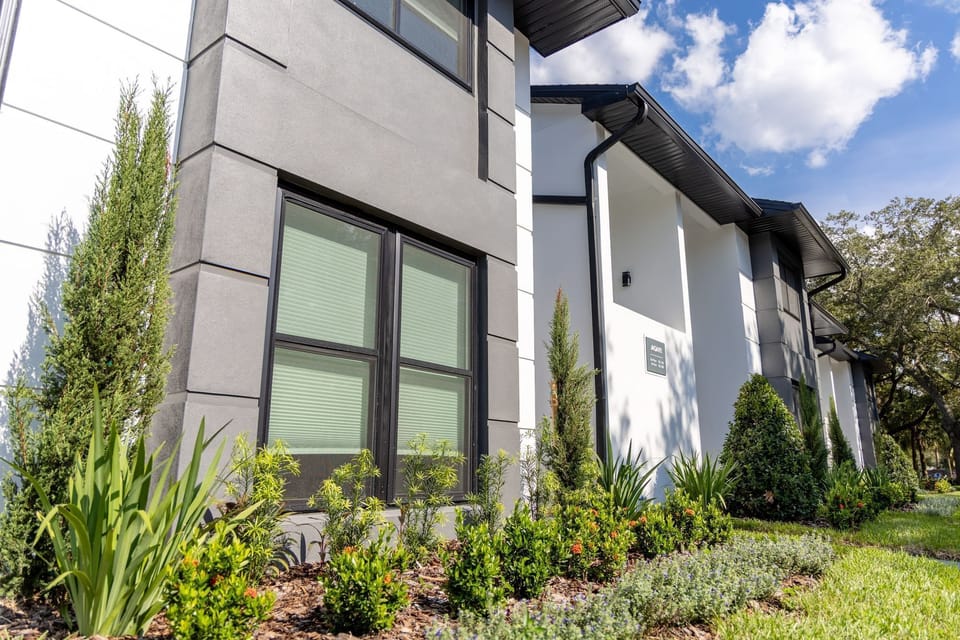 Arrive to crisp modern lines and lush landscaping outside.