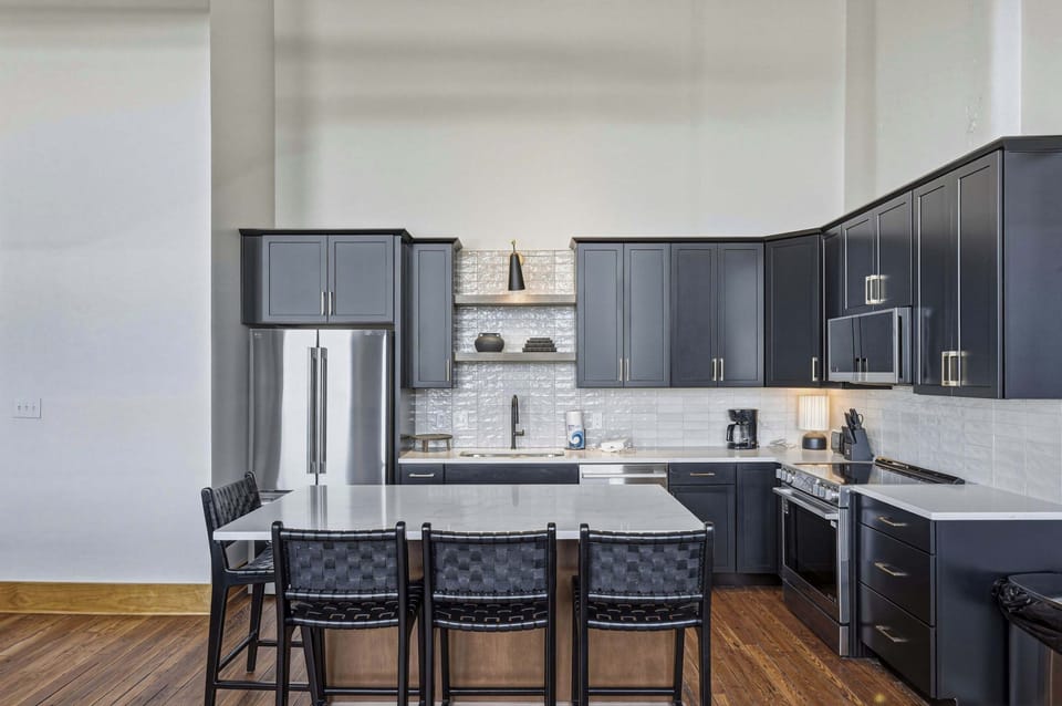 Premium appliances and clean-lined finishes reflect the home’s commitment to elevated comfort.
