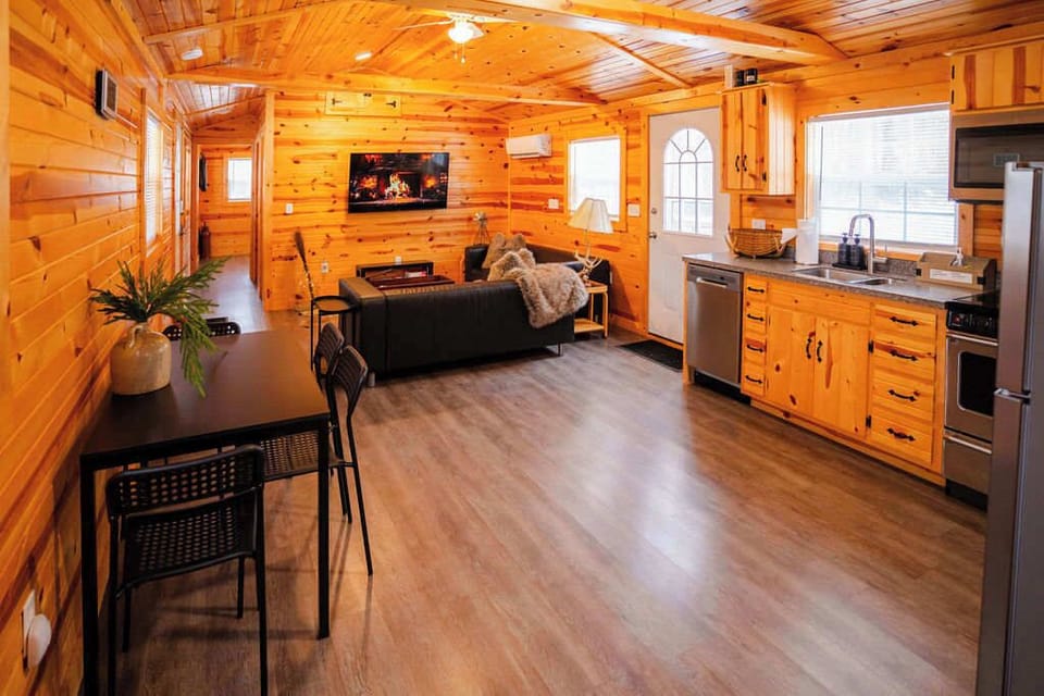 Living Room: Sleek design with natural wood accents and a comfy sectional for relaxing evenings!