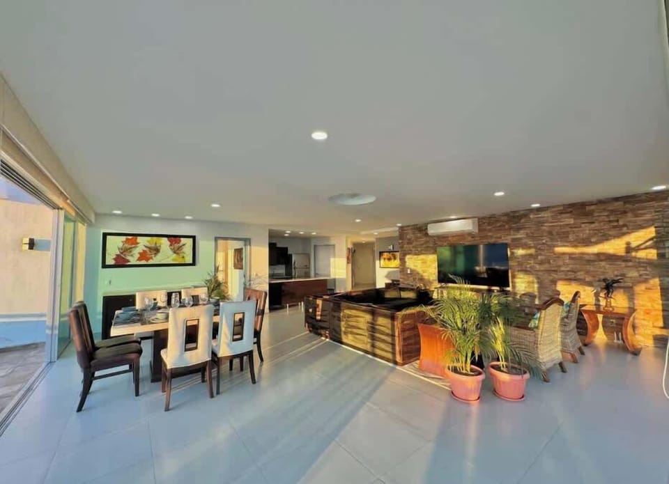 Bright open dining area w/ large table & modern lighting for group meals