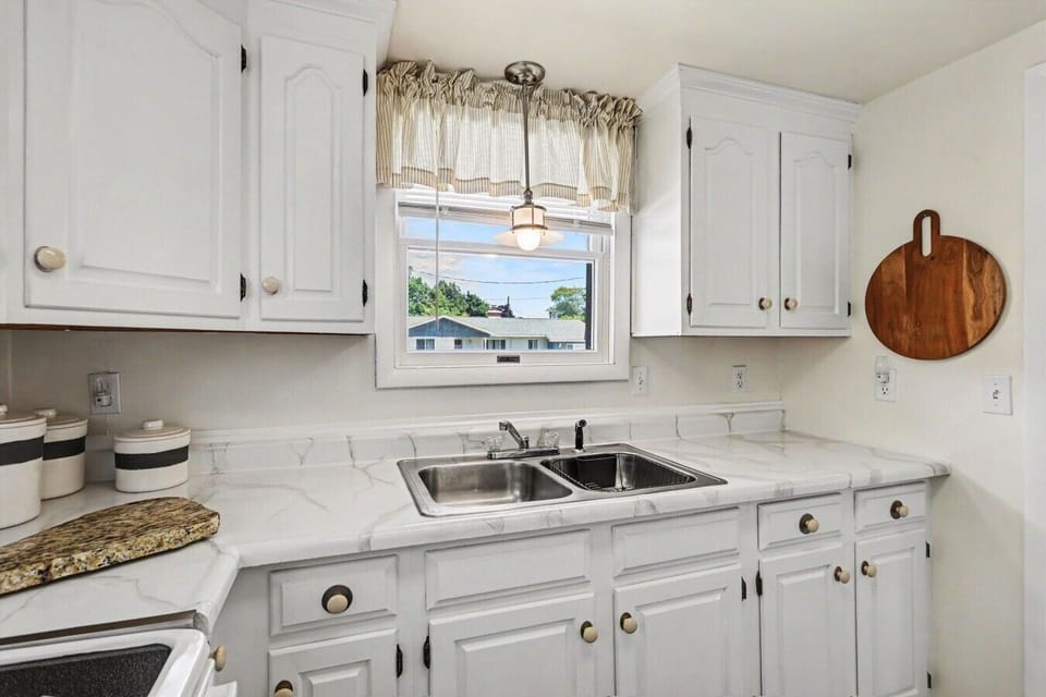 Kitchen | Double Basin Sink | White Cabinetry & Marble Countertops