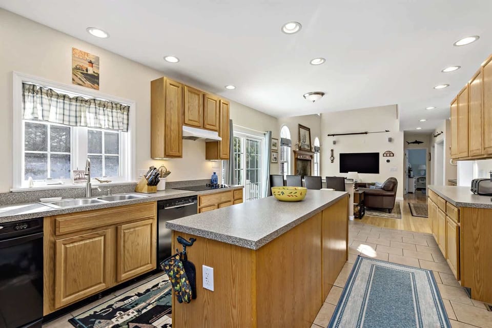 Spacious kitchen with a center island and plenty of counter space, ideal for preparing fresh lobster and seafood dinners. 