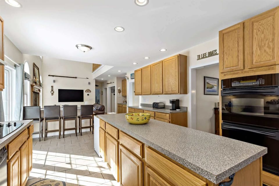 Gather, cook, and relax in this South Chatham Cape Cod rental with a large kitchen island and open living space.