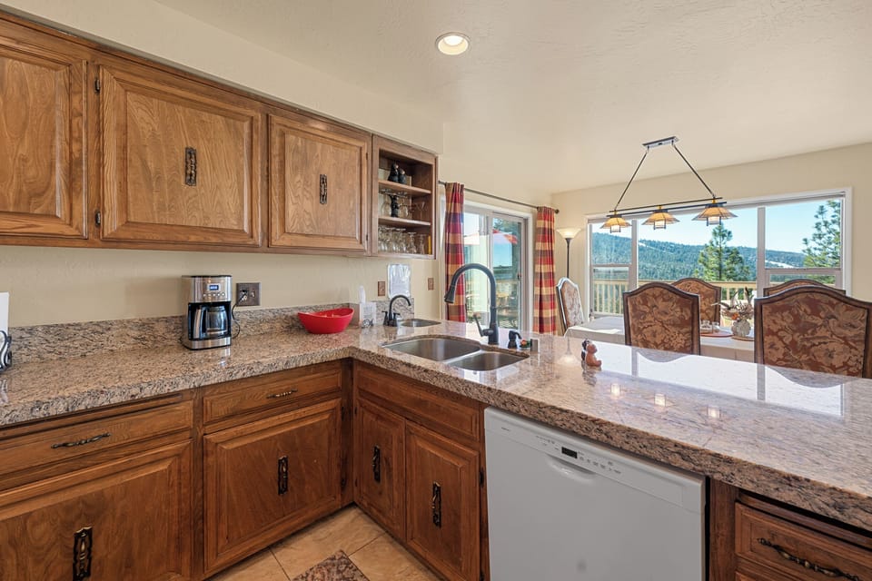 Full Kitchen - The fully stocked kitchen includes granite countertops, full-size appliances, cookware, and a coffee maker.