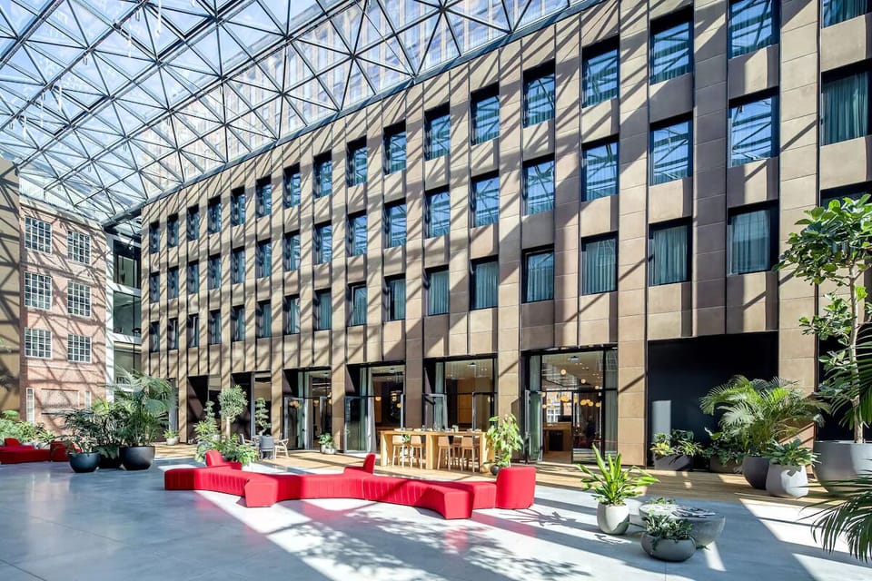 Unwind in the sunlit atrium courtyard with lush seating.