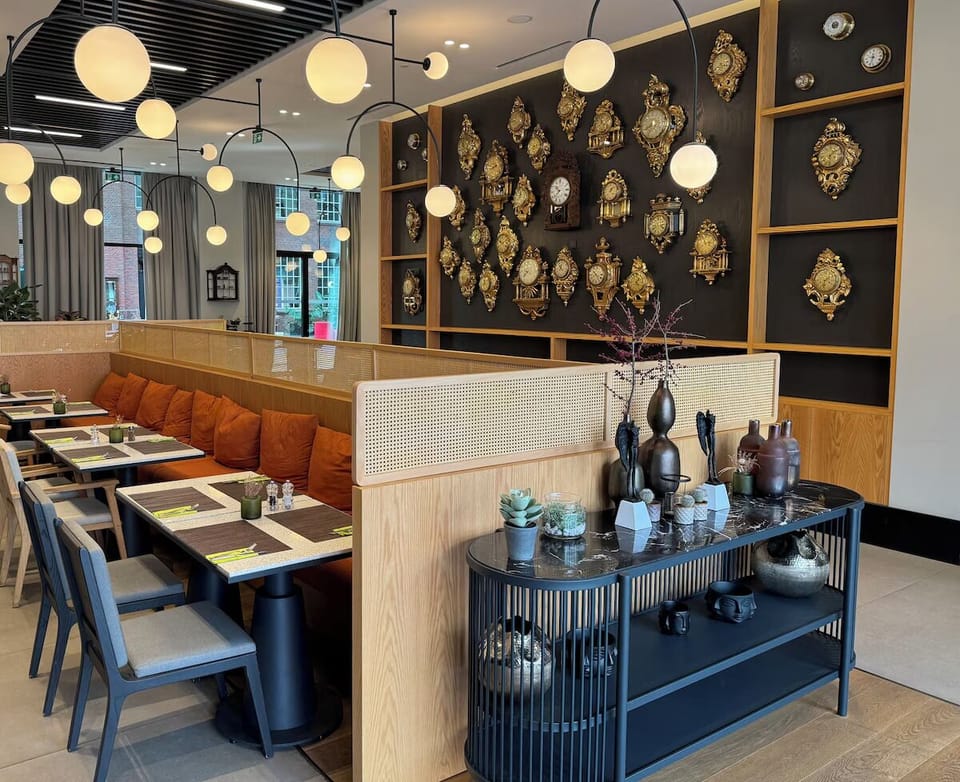 Settle into cozy banquettes under glowing lights and artful decor.