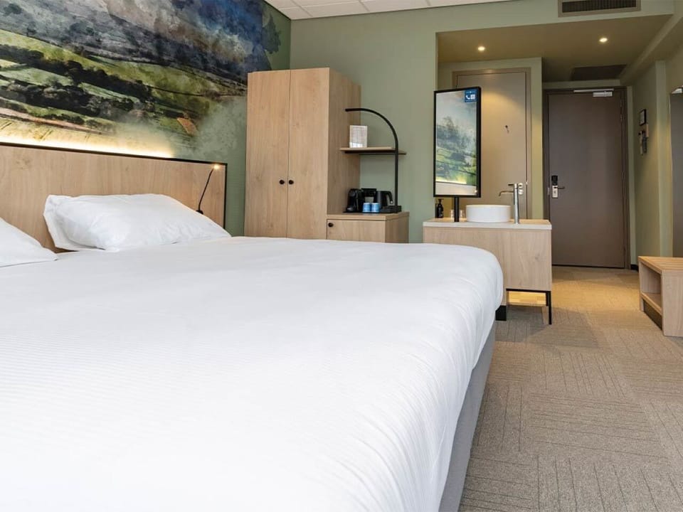 Relax in a serene bedroom with warm wood finishes.