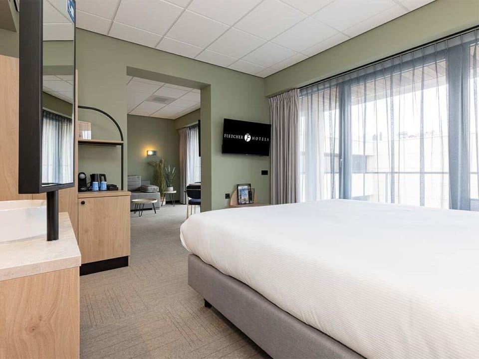 Wake to soft daylight pouring through floor-to-ceiling curtains.