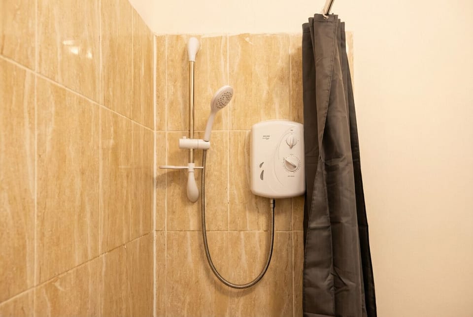 Power shower with warm stone tiling for a refreshing start to every morning.