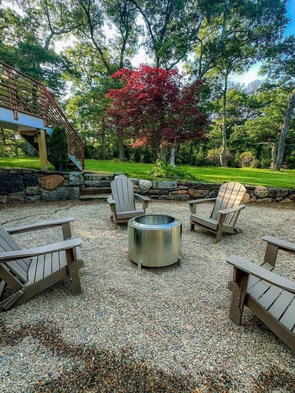 Lower level seating area with fire pit and hammock swings