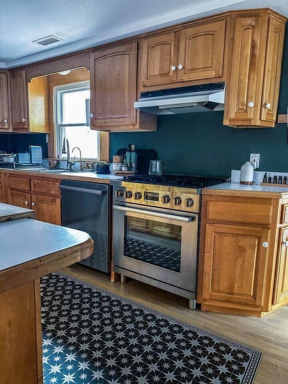 Large open kitchen with commercial gas stove, dishwasher and breakfast island. 