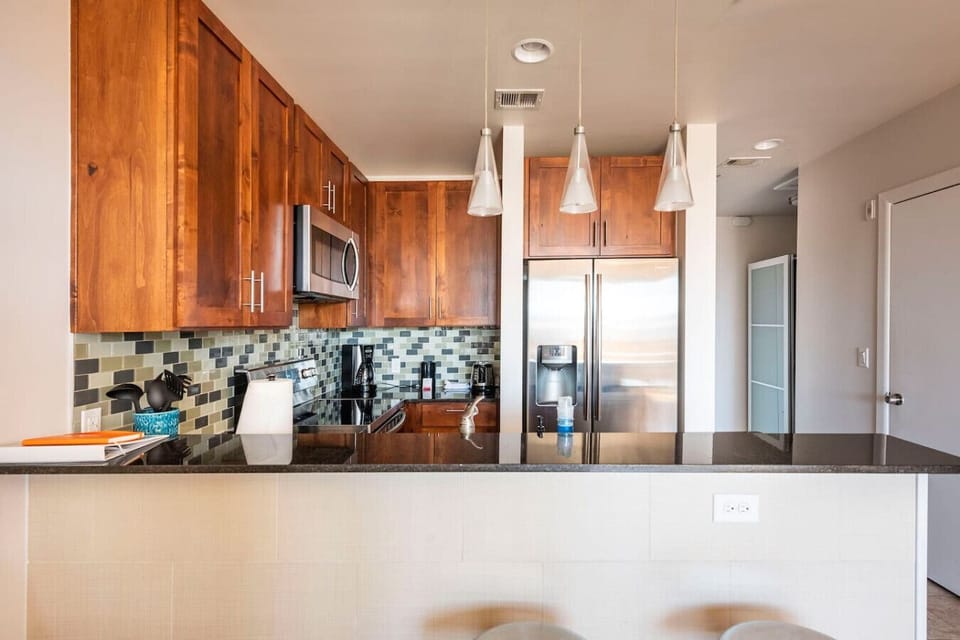 Whip up meals in a sleek kitchen with warm wood, stainless steel, and style.
