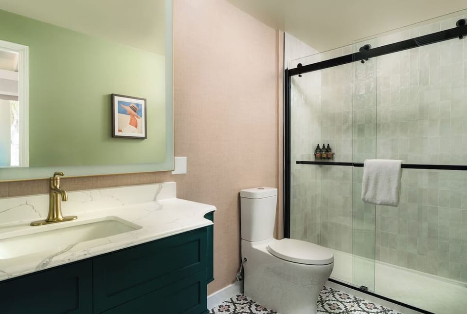 Rinse off in a spotless shower with sleek glass doors.