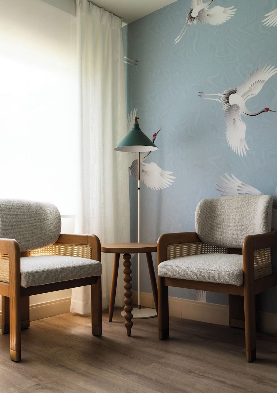 Sip coffee in the sunny sitting nook beside soft curtains.