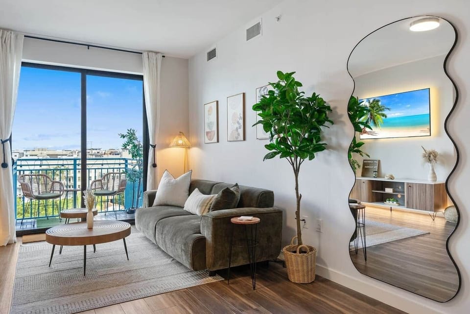 Enjoy the airy, sunlit living room that opens to a private balcony with city views—perfect for sipping morning coffee or relaxing in the evening.