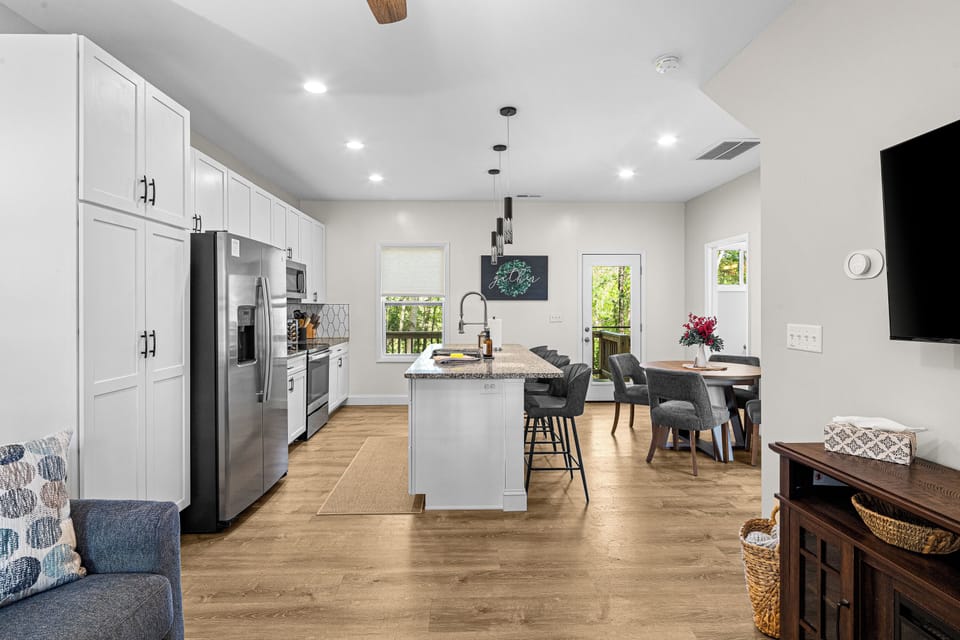A bright, fully stocked kitchen designed for gathering. Stainless appliances, granite countertops, and island seating invite slow breakfasts, shared meals, and effortless entertaining with seating and place settings for eight.