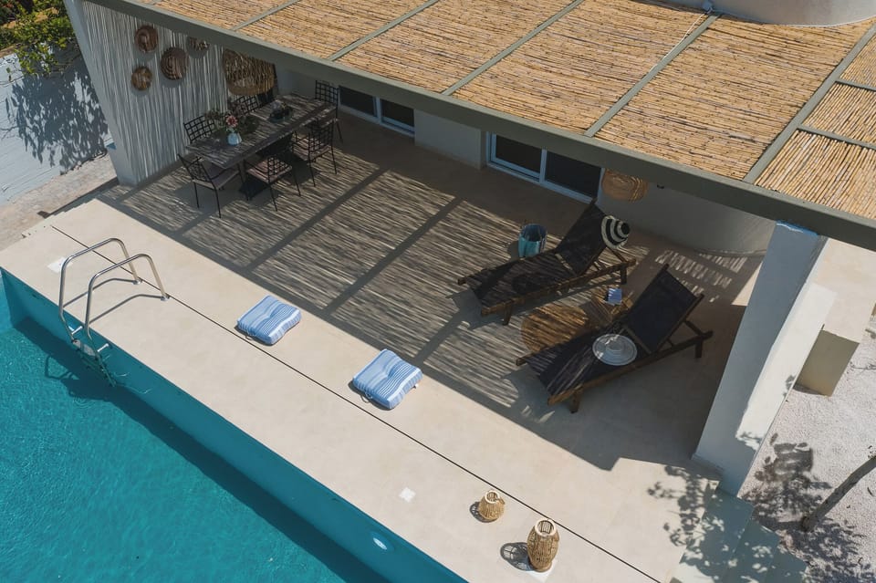 Aerial view — outdoor area featuring pool, sun loungers, and dining